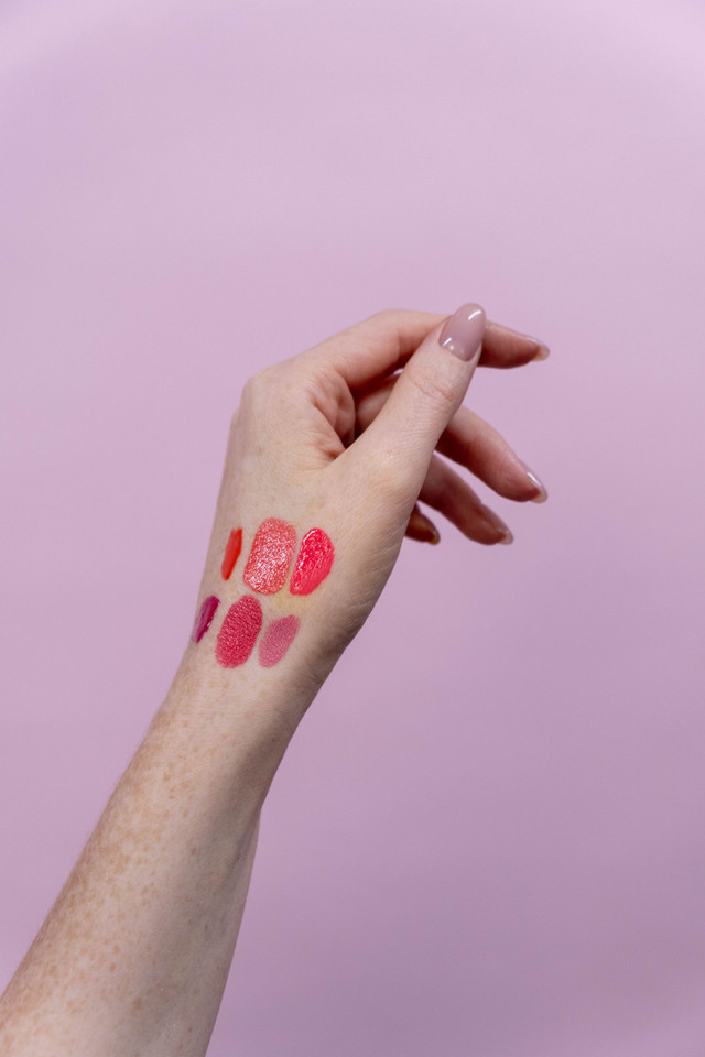 Lipstick swatches on the back of a hand, on fair skin.